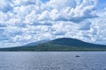 Cloud day landscape with fisherman at Zyuratkul lake