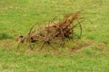 Antique agricultural vintage hay mower farm equipment in large field