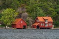 Red house together with a boathouse close to sea Royalty Free Stock Photo