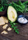 ÃÂvocado, rocket salad, crackers and cacÃÂ±k on wood