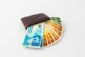 Ãârown leather wallet and stack of banknotes new Israeli shekels on white background Royalty Free Stock Photo