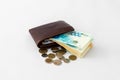 Ãârown leather wallet and stack of banknotes and several coins of new Israeli shekels on white background Royalty Free Stock Photo