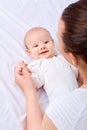 ÃÂ appy mother with baby on the bed.Smiling,laughing, happiness,playing.