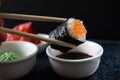 ÃÂ iece of sushi with caviar. Sushi eaten with chopsticks.