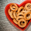 ÃÂ¢op view. Bagels on red plate in shape of heart on gray background.