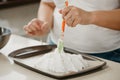 ÃÂ photo of hands of a woman who is creating with a scapula a form of a meringue