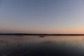 ÃÅ¡ÃÂ°yaking people on the calm water of the lake in the sunset light return from a hike