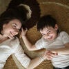 Beautiful brunette mom playi and hugging with son Stock Photo