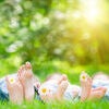 Family lying on grass. Outdoors in spring park Stock Photo