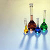 Volumetric Flasks. Of varying sizes with colorful liquids Stock Photo