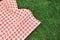 000Red picnic  towel on green grass top view, checked cloth flat lay. Food advertisement display