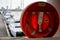 01/29/2020 Gosport, Hampshire, UK An Orange lifebuoy on a quayside with the focus on the lifebuoy and sailing boats in the