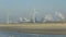 01-30-2012 IJmuiden,The Netherlands.Man on the beach with wind turbines and Tata steel in the back