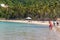 02/06/2019 - Philippines, island Palawan, El Nido: Tropical beach with tall trees and relaxing people. Seascape with tourists.