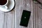 02/10/2021 Portsmouth, Hampshire, UK A mobile phone or cell phone laid on a wooden table with the wimbledon tennis app open on