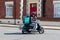 04/01/2020 Portsmouth, Hampshire, UK A Deliveroo delivery driver riding his scooter with a deliveroo box on the back