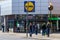 04/01/2020 Portsmouth, Hampshire, UK Shopper queuing outside a Lidl supermarket standing two meters apart during the Covid-19 or