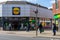 04/01/2020 Portsmouth, Hampshire, UK Shopper queuing outside a Lidl supermarket standing two meters apart during the Covid-19 or