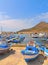 04.09.2018. view of the port of Favignana with small fishing boats, typical houses and sea and mountains in background, Sicily Ita