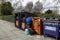 04-11-2021 Portsmouth, Hampshire, UK A Row of charity clothes collection bins on a street overflowing with donations