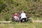 04-19-2021 Portsmouth, Hampshire, UK Grandparents sitting with their grandchild on a picnic bench in the sun eating in spring