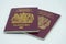 04/23/2020 Portsmouth, Hampshire, UK Two maroon British passports isolated on a white background