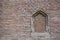 04/28/2020, in Augsburg, Germany, view of the outer wall at Augsburg Cathedral made of red bricks and a bricked-up window