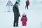 05.01.2020, Russia, Syktyvkar: Little girl with her father stand against snowy street