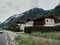 05-07-2018 Austria. Road to mountain near raditional mountain house