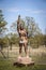 05-14-2020 Bartlesville USA - Native American Man statue with loincloth and headband raising hand in greeting outside Woolaroc