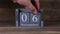06 setting date on wooden cube calendar for November months