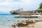 08-15-2015, Trogir, Croatia. Abandoned shipwreck washed ashore spoiling Adriatic Sea coastline.