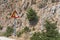 08.20.2023. Crete, Greece. Roadside traffic warning sighn 'Land Slide' on rocky mountenious road