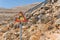 08.20.2023. Crete, Greece. Roadside traffic warning sighn 'Land Slide' on rocky mountenious road