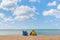 08-29-2020 West Bay, UK. A couple comfortably sitting in beach chairs enjoying undisturbed view at quiet and calm sea waters.