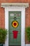 08/30/2020 Hambledon, Hampshire, UK sunflower artwork on the front door of an old English cottage