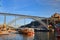 09 of December, 2018 - Porto, Portugal: View of the historic city with the Dom Luiz bridge. A metro train can be seen on the bridg