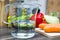 1/2 Liter / 500ml / 5dl Of Water In A Measuring Cup On A Kitchen Counter With Vegetables