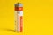 1.5 volt alkaline battery, AA size, on yellow background