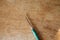 1.75 mm crochet hook with green handle on wood