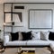 1 A chic, modern living room with a mix of white and black finishes, a low sectional sofa, and a large, statement art piece4, Ge