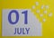 1 july calendar date on a white puzzle with separate details. Puzzle on a yellow background with a blue inscription