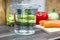 1 Liter / 1000ml / 10dl Of Water In A Measuring Cup On A Kitchen Counter With Vegetables