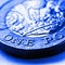 1 one British pound coin. Blue tinted square illustration about money and economy of Great Britain. Brexit. Focus is on