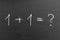 1 plus 1 math equation formula with question mark on a chalkboard