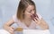 1 white girl with short hair eating a donut with coffee