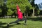 1 white young woman in a warrior pose in the Park, a girl doing yoga among the trees