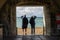 10/09/210/09/2019 Portsmouth, Hampshire, UK two men stood in an archway at the beach looking out to sea shading their eyes from