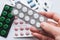 10 tablets in a silver blister in hand on a white background close-up. The concept of medication