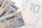 10 Tunisian dinars bills lies in stack on background of big semi-transparent banknote. Abstract business background